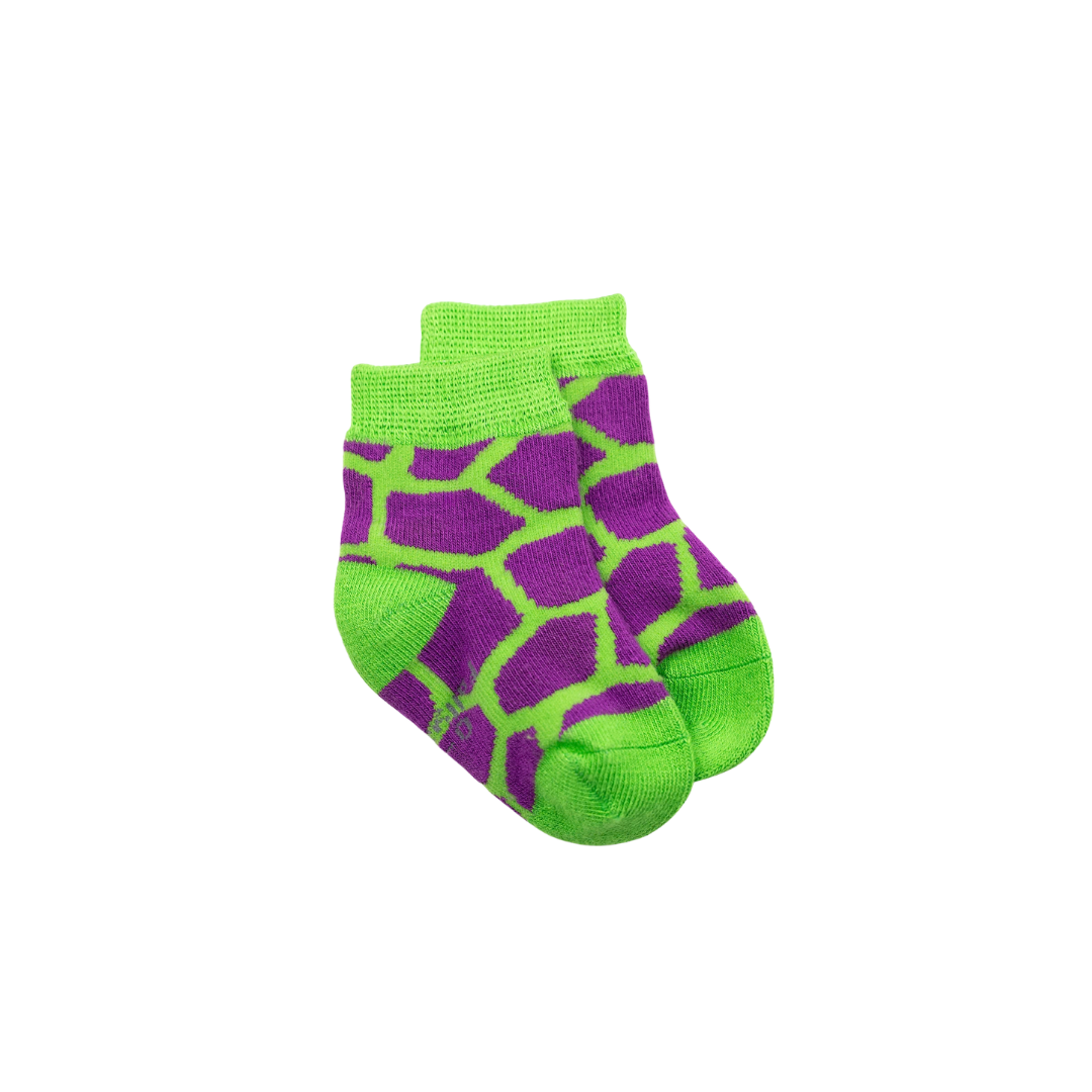 A pair of seamless bamboo baby crew socks featuring a purple and bright green giraffe-like spot pattern, with solid green ribbed cuffs, heels, and toes, displayed on a clean white background.