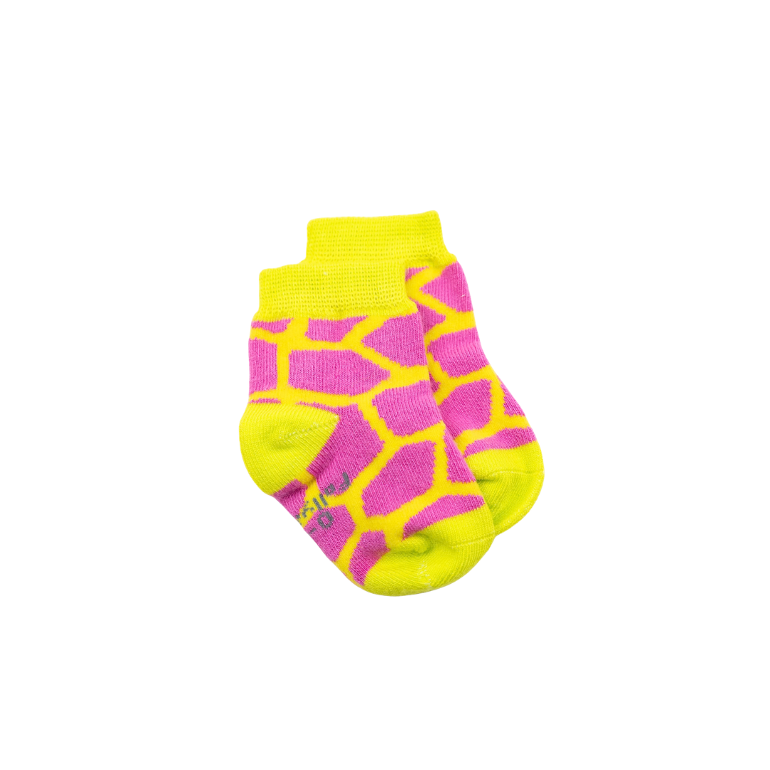 A pair of seamless soft top baby bamboo crew socks with a bright pink and neon yellow giraffe-print pattern, featuring a neon yellow cuff, heel, toe, and sole, shown against a plain white background.