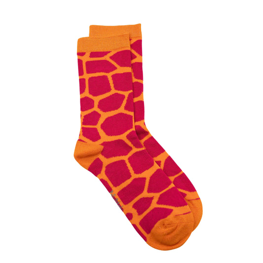 A pair of crew bamboo seamless socks featuring a giraffe-inspired pattern with bright orange and red sections, shown against a plain white background.